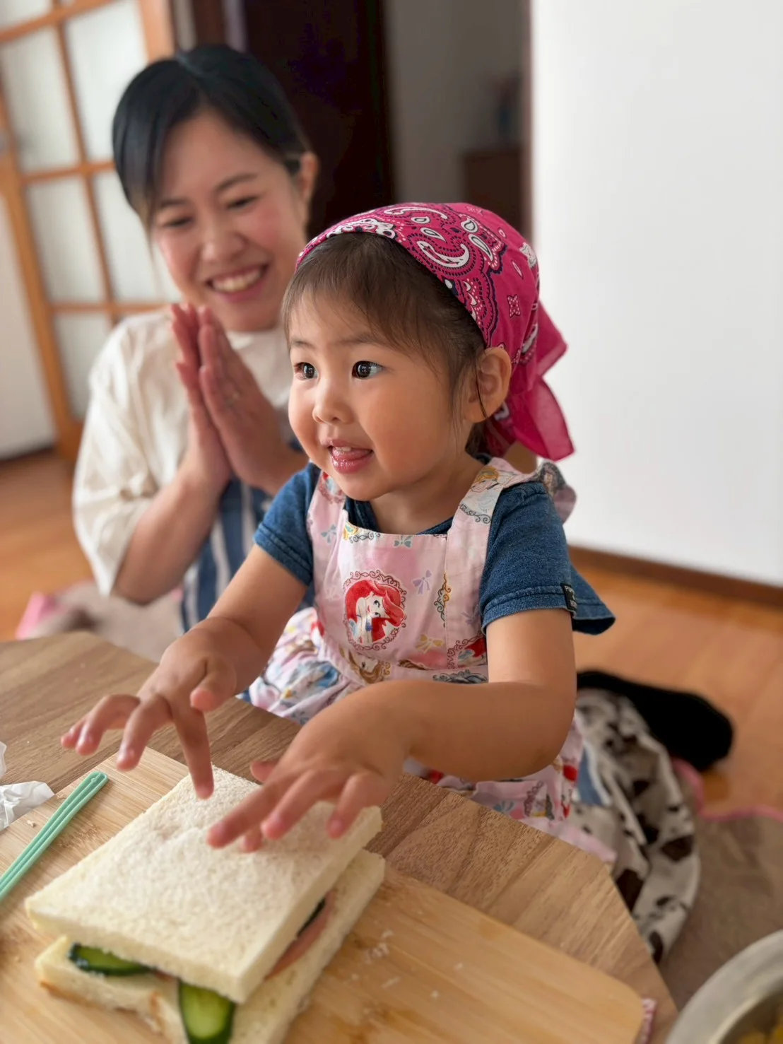 お母さんに見守られながら料理をする子ども